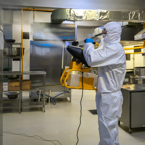 man in protective equipment disinfects surfaces due to coronavirus covid-19 .Virus pandemic.